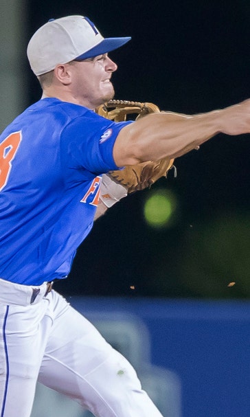 JJ Schwarz smacks grand slam, Florida blanks FSU to advance to College World Series